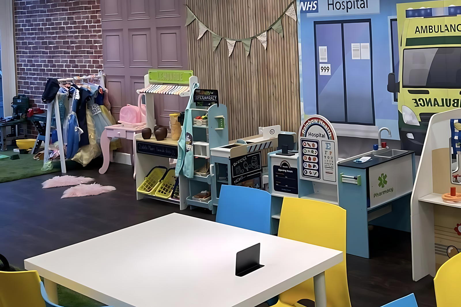 The role-play village at Mollie's Party Paradise, with a pretend supermarket, hospital and dressing-up rail.