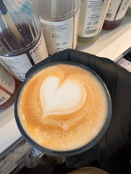 A latte with heart-shaped latte art, made at the Mollie's Party Paradise coffee bar.