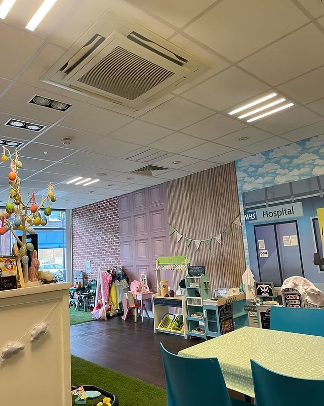 The role-play area with a pretend hospital, supermarket stall and dressing-up corner.